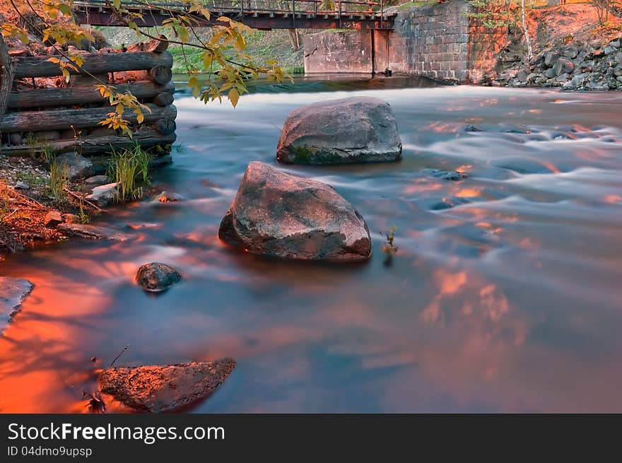 River landscape with the bridge stones and an old timbered felling