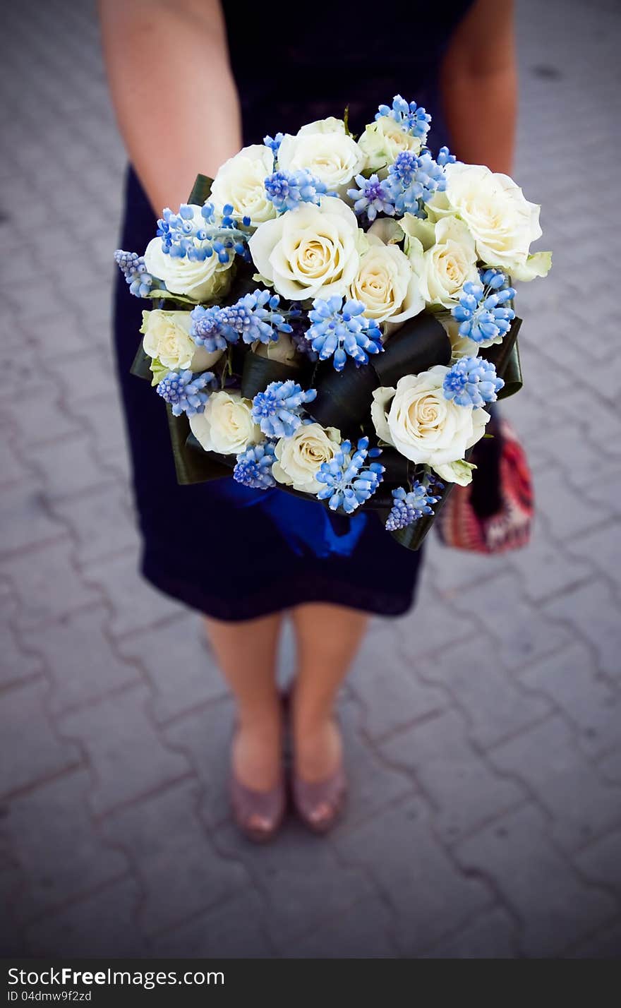 Bridesmaid holding colorful wedding bouquet