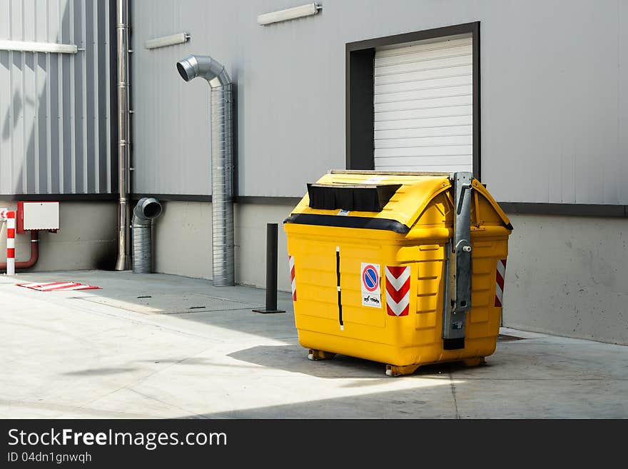 Yellow garbage can for plastic recycling  in warehouse. Yellow garbage can for plastic recycling  in warehouse.