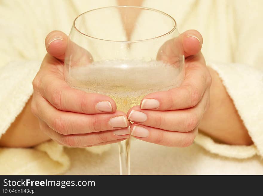 Hands holding wine glass with bubbly liquid. Hands holding wine glass with bubbly liquid.