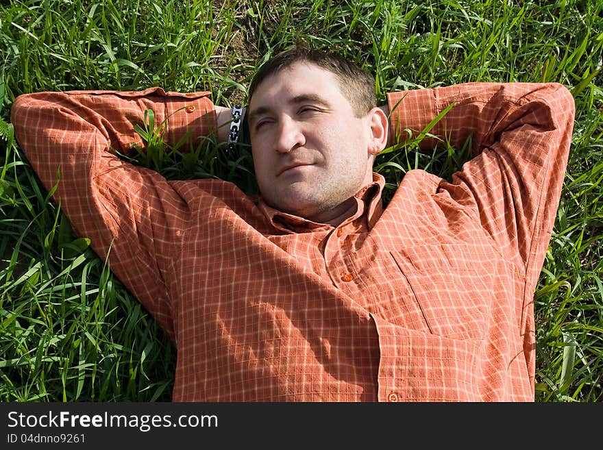 Young man lying on the grass