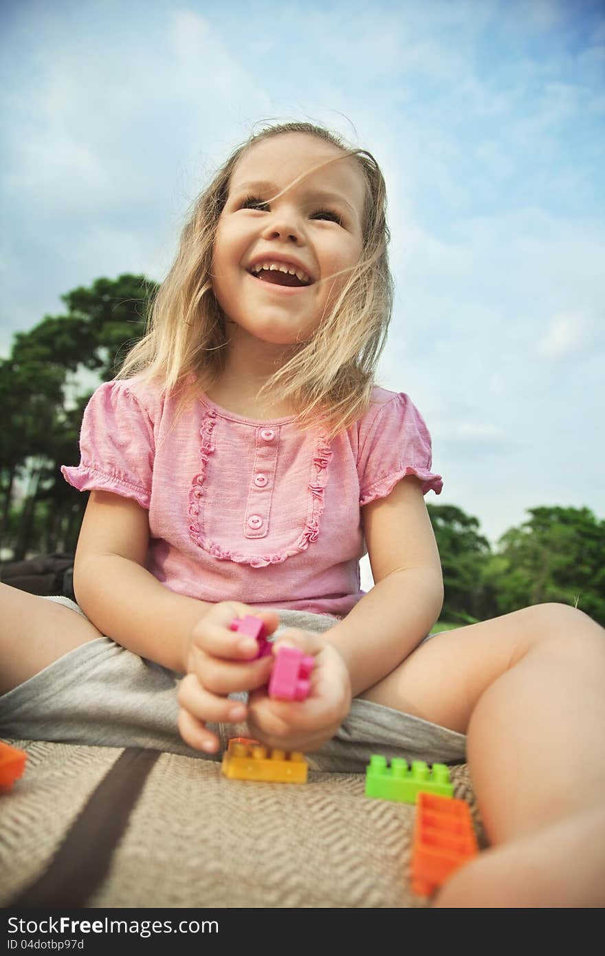 Girl Playing Outdoors With Constructor