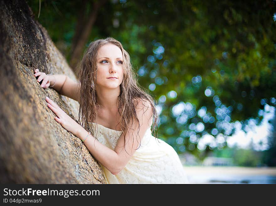 A beautiful young girl in a white dress with a sto