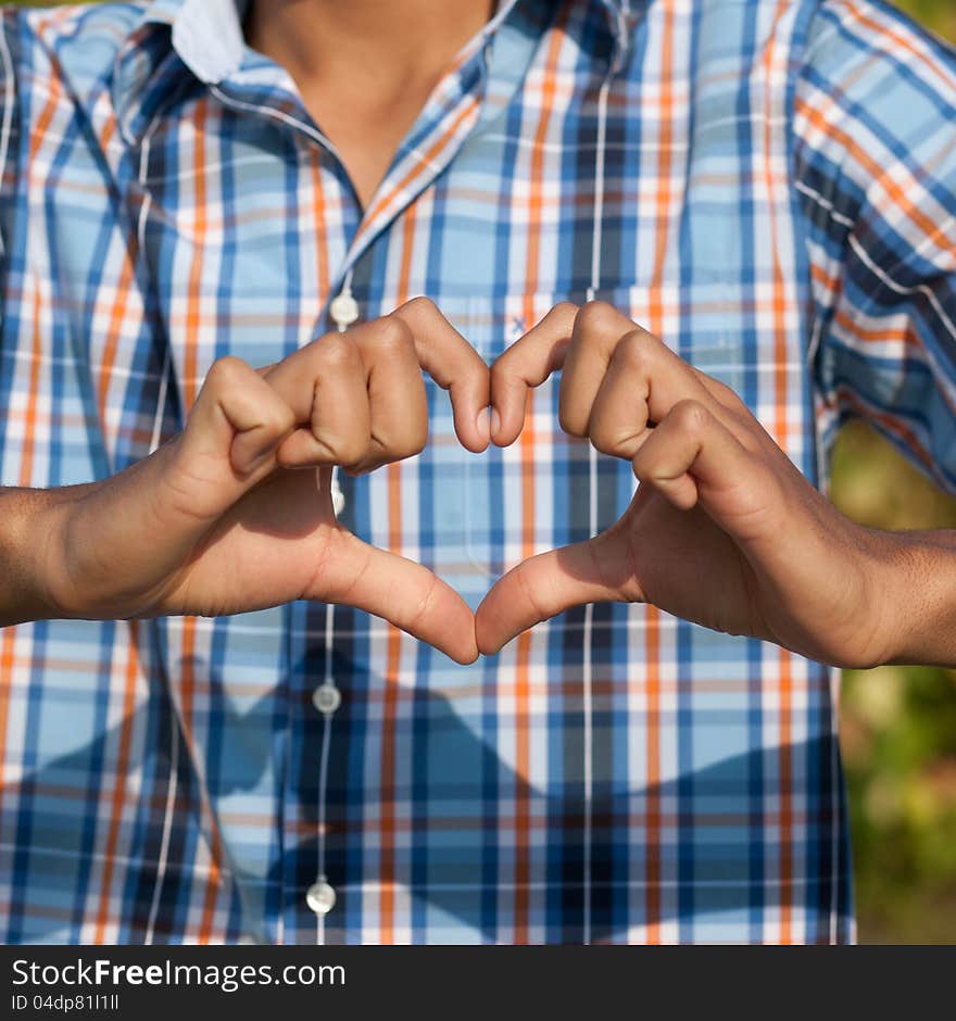 Young man show love sign outdoor