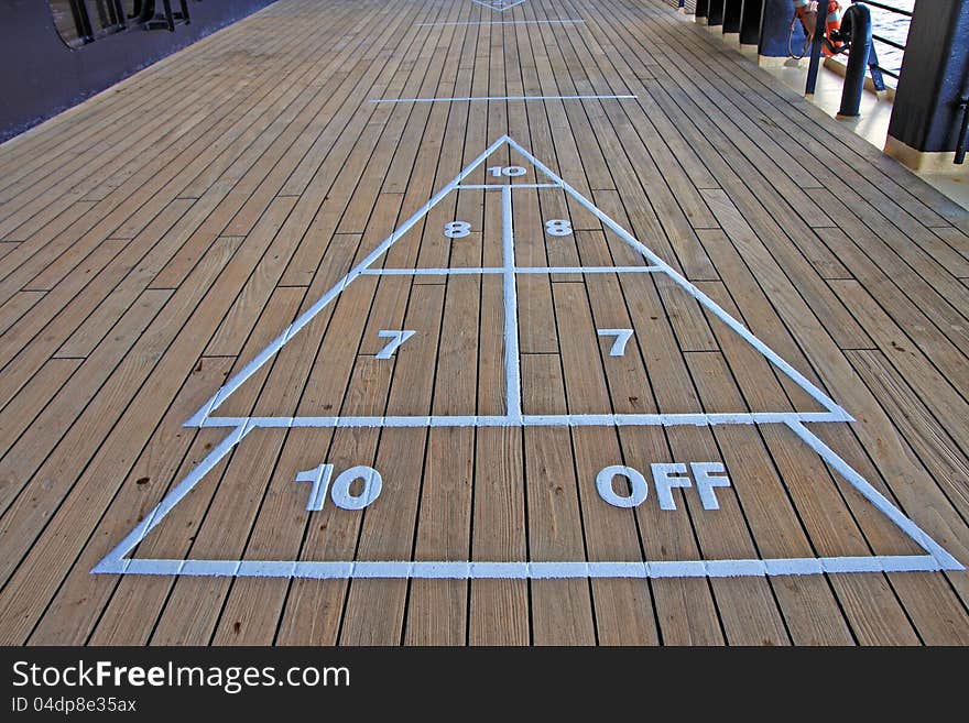 Shuffleboard onboard a cruise line ship on a wooden deck