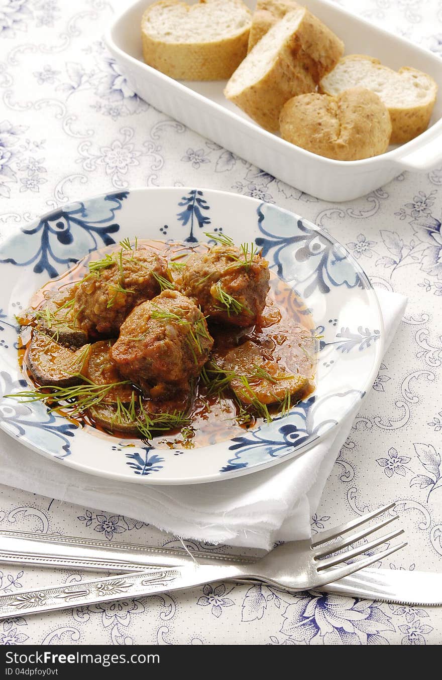 Meatballs with zucchini in tomato sauce