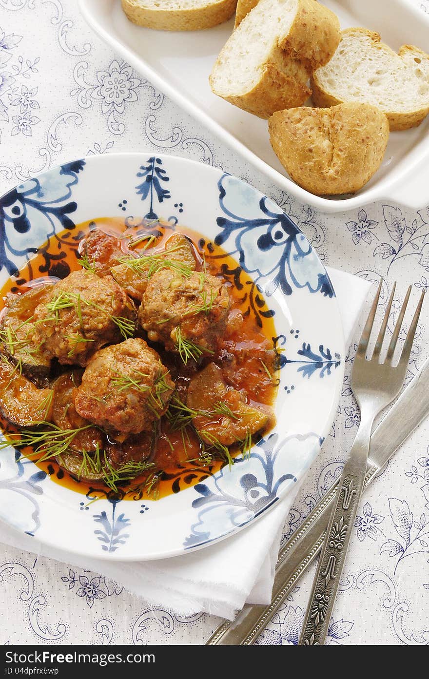 Meatballs with zucchini in tomato sauce