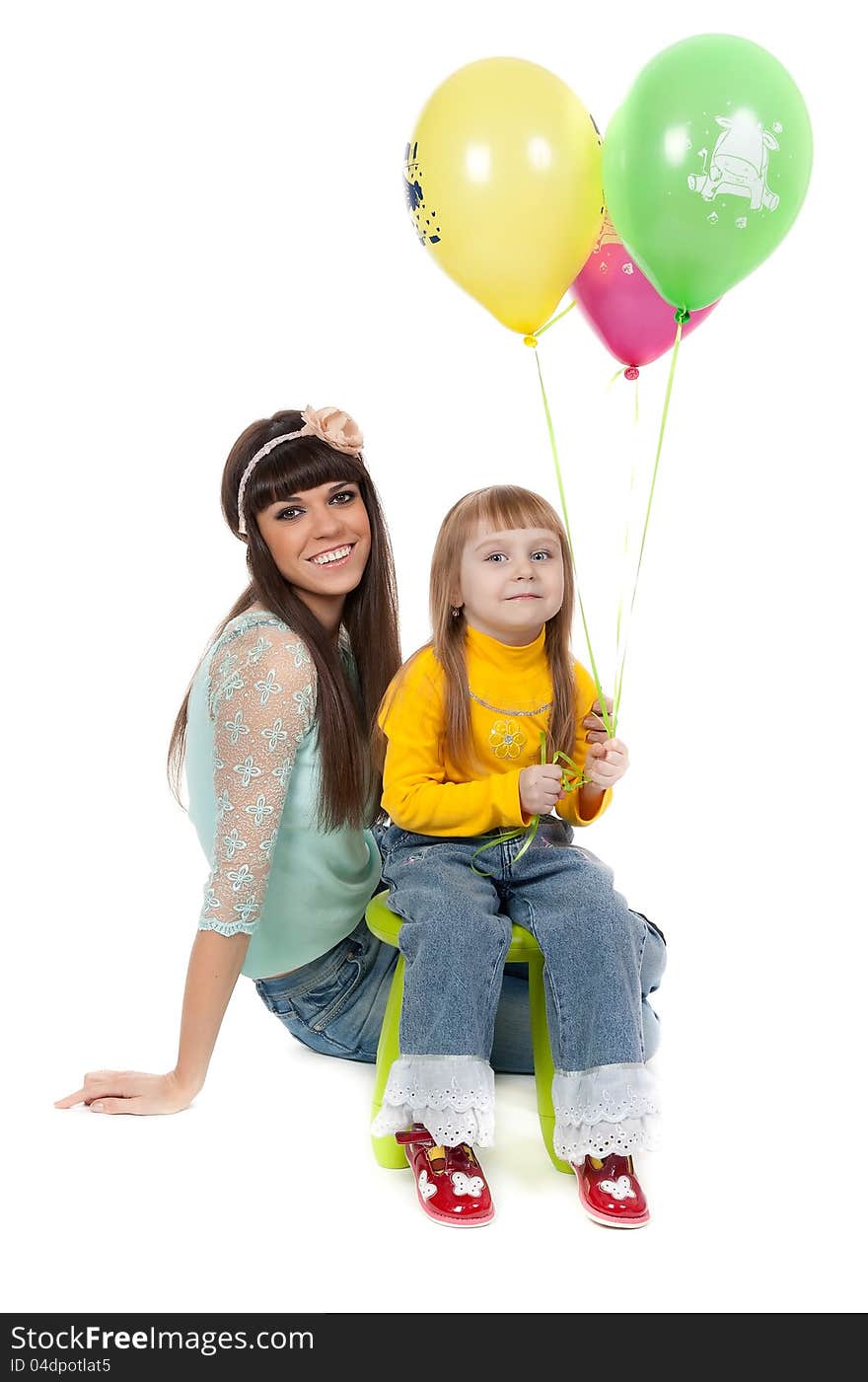 Studio shot of mother and daughter with balloons