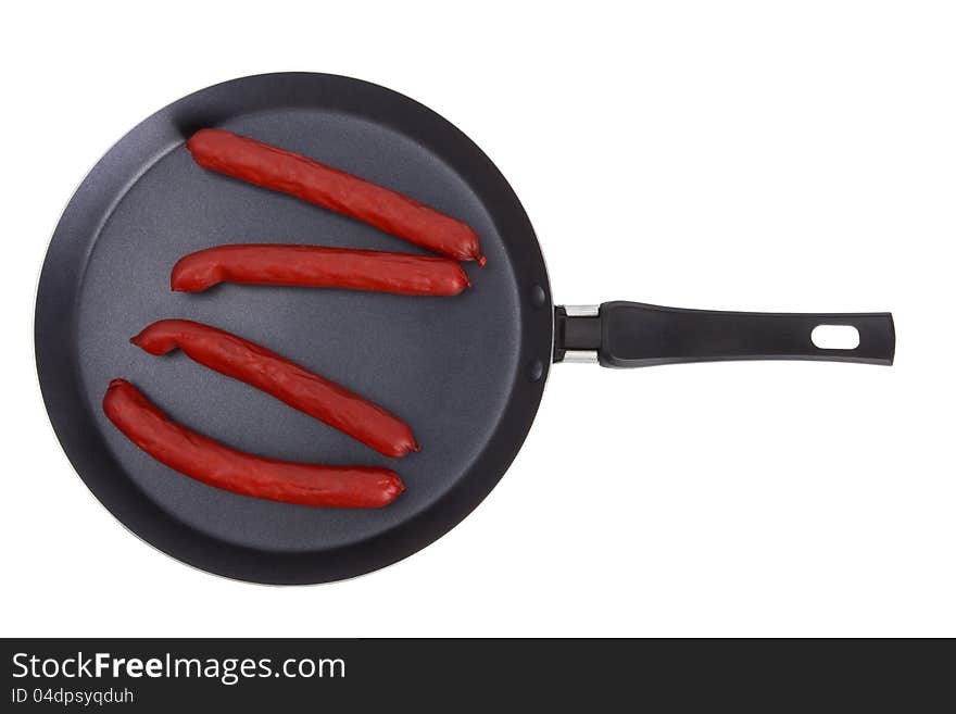 Fried sausages on frying pan isolated on a white