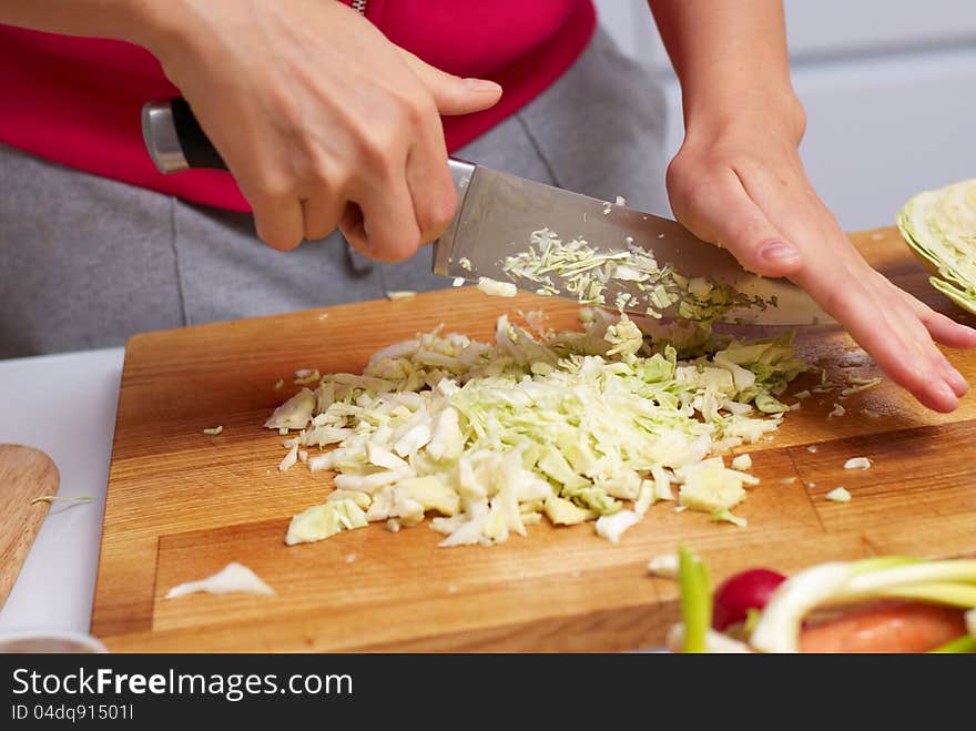 Female Hands Slicing Cabbage