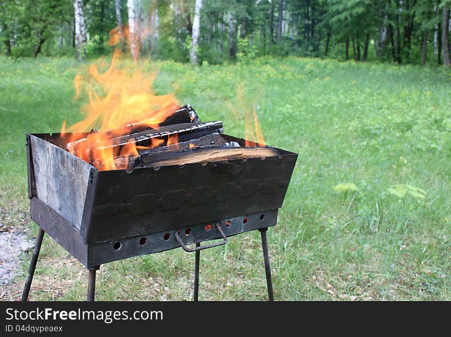 Burning wood in a brazier in the summer