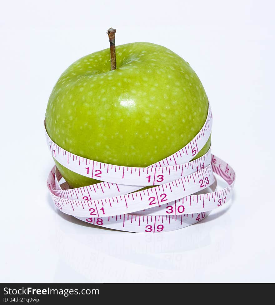 Green apple wrap with tape measure on white background. Green apple wrap with tape measure on white background