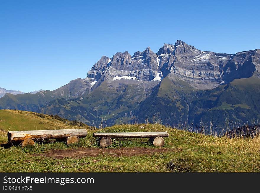 Observation deck with wooden benches in the Swiss Alps. Observation deck with wooden benches in the Swiss Alps