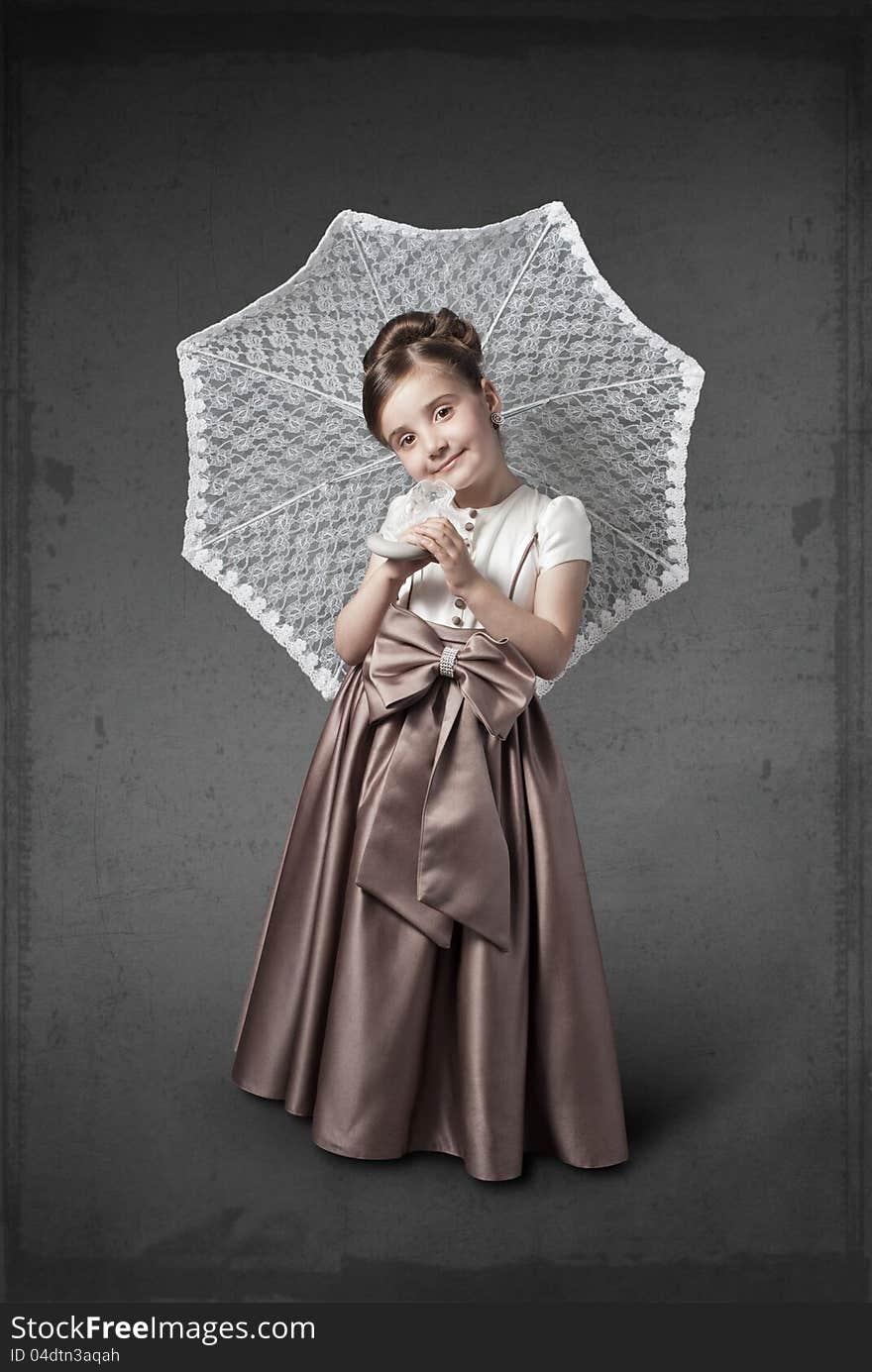 Girl in a luxurious dress with an umbrella