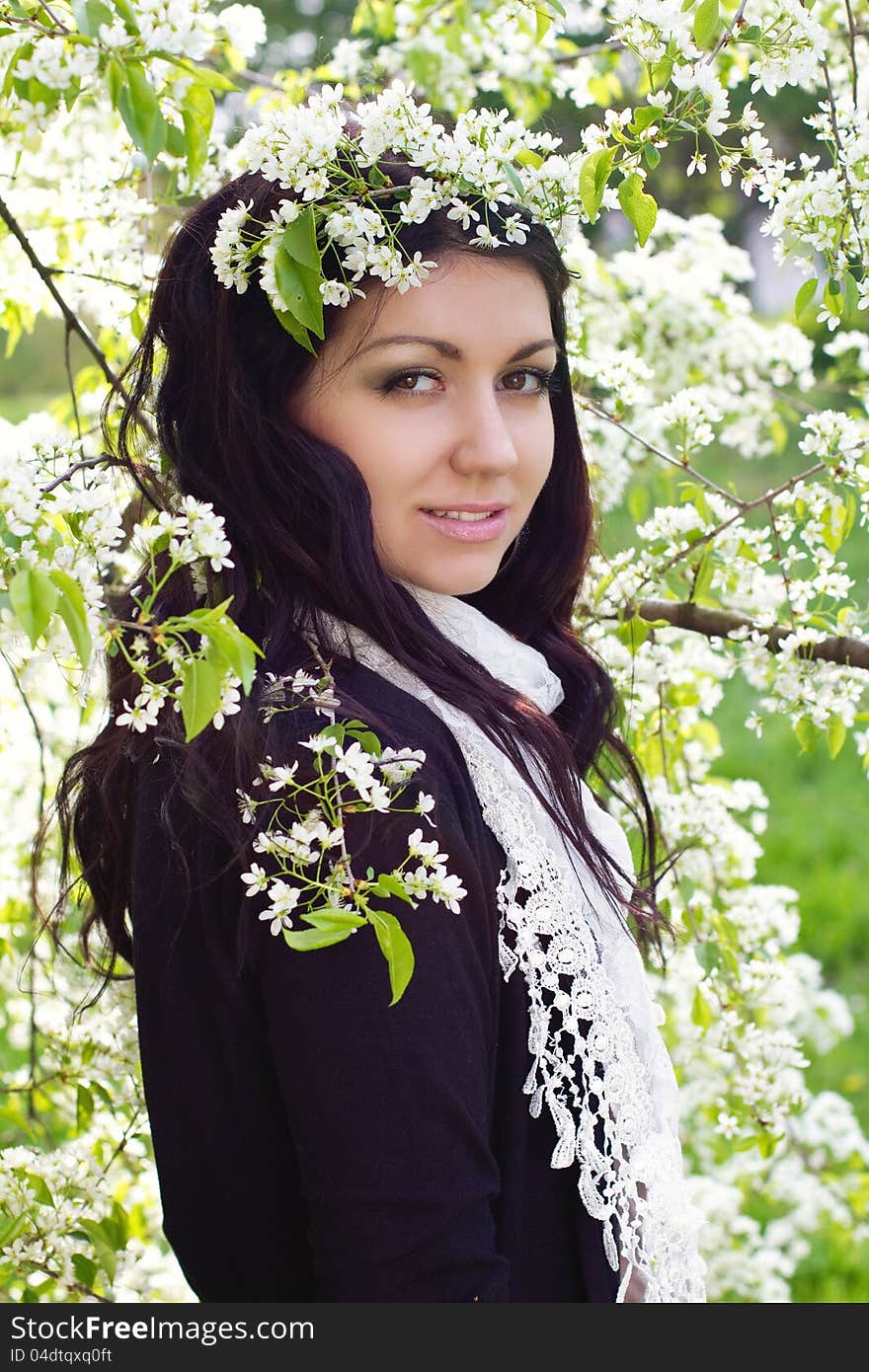 Portrait of young brunette in the spring garden. Portrait of young brunette in the spring garden