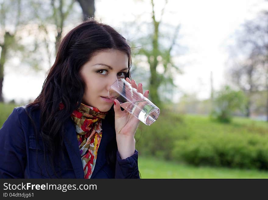 Young woman with glass of water, outdoors. Young woman with glass of water, outdoors