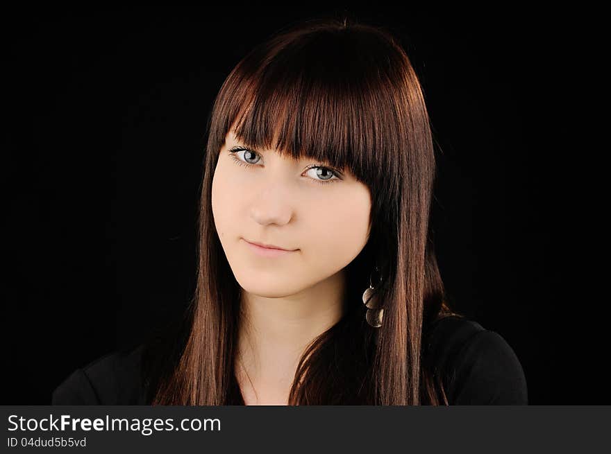 Portrait of beautiful smiling young girl. Other black background