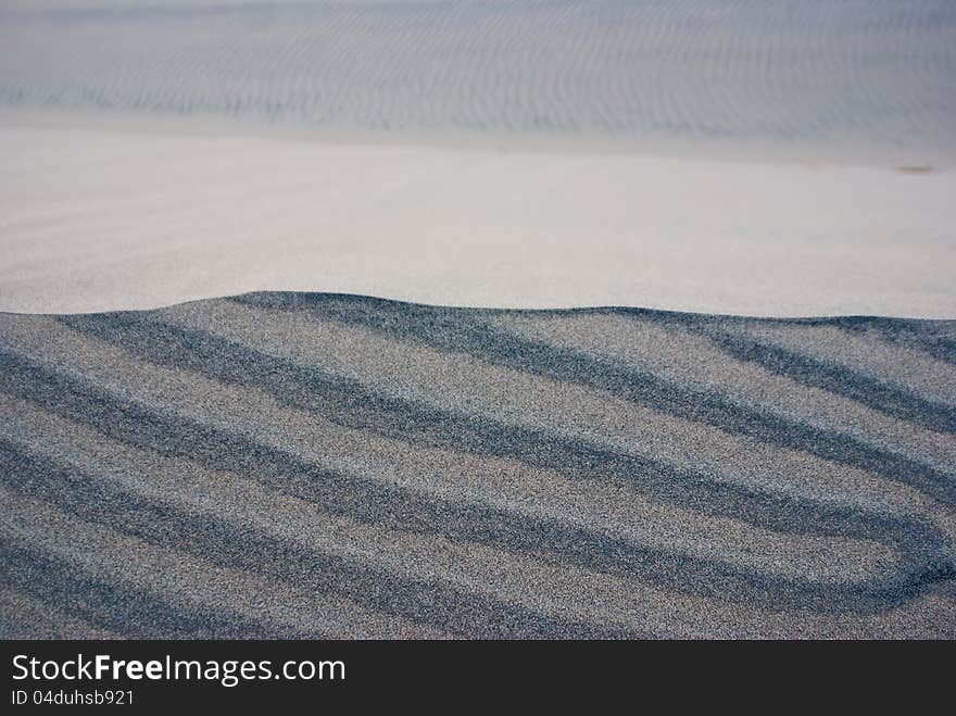 Layers of different colored sand in desert dunes. Layers of different colored sand in desert dunes