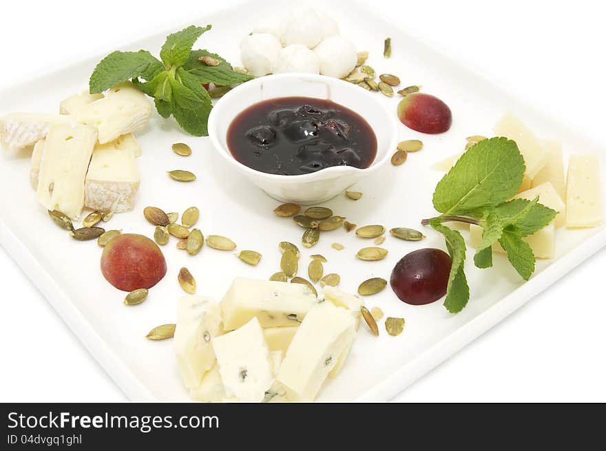 Cheese plate with several kinds of cheese on a white background