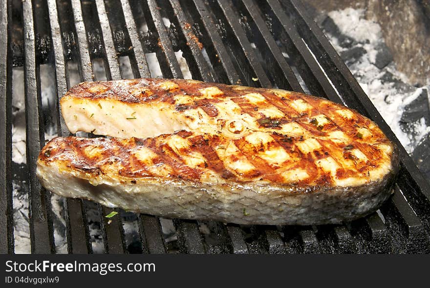 Salmon steak cooked on a grill in the restaurant