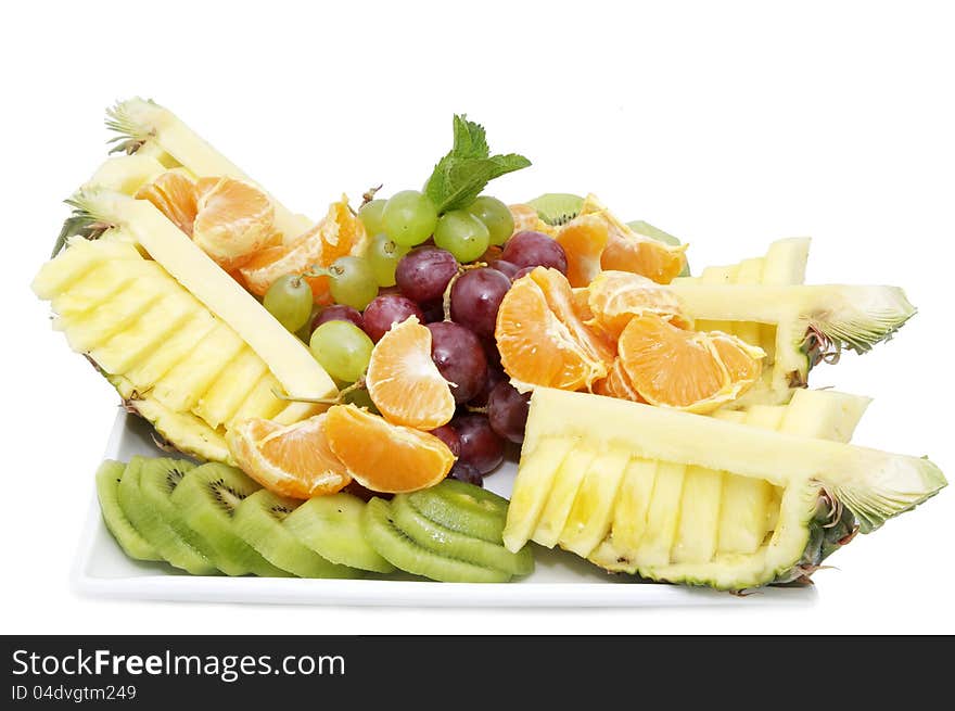 A plate of ripe juicy fruit on white background