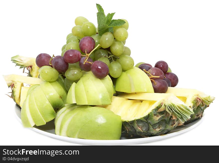 A plate of ripe fruit on a white background