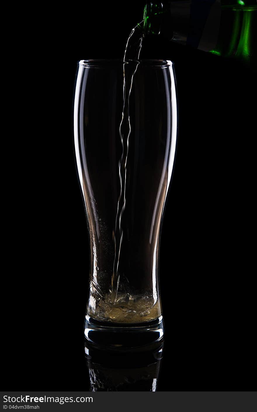 Fresh beer with froth and condensed water pearls on black background. Fresh beer with froth and condensed water pearls on black background