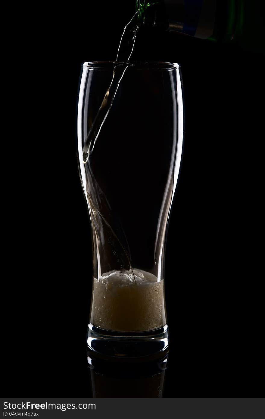 Fresh beer with froth and condensed water pearls on black background. Fresh beer with froth and condensed water pearls on black background