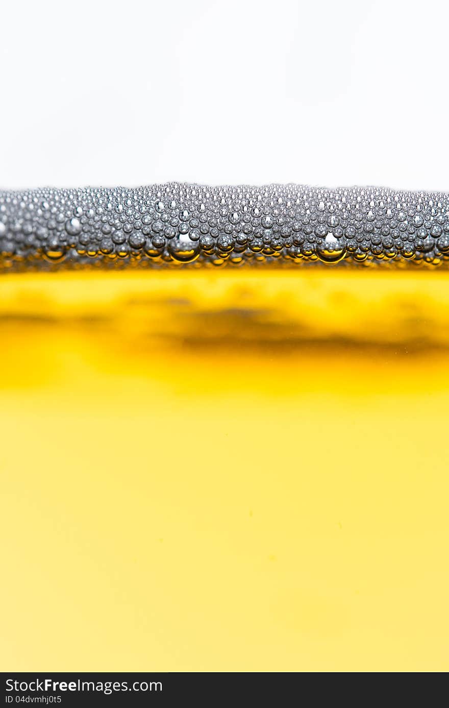 Fresh beer with froth and condensed water pearls on white  background. Fresh beer with froth and condensed water pearls on white  background