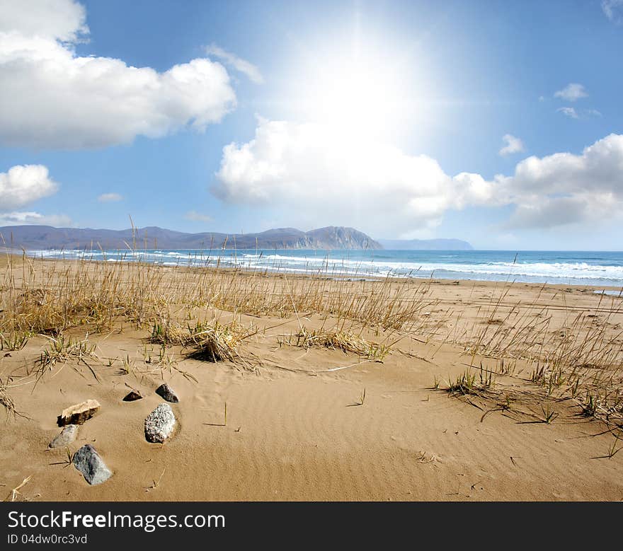 Scenery with sea, sand and clouds