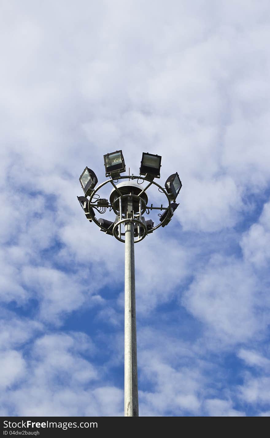 Spot-light tower in blue sky with cloud