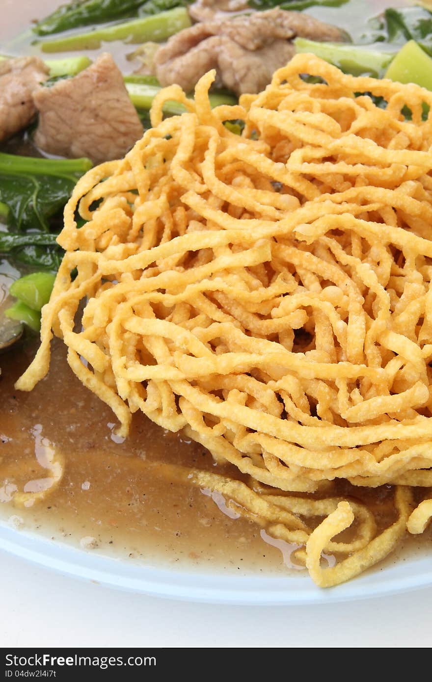 Crispy yellow noodle with in a creamy gravy sauce