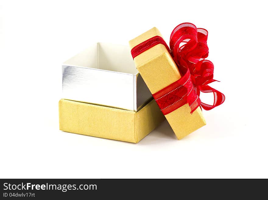 Opened gift box and red ribbon on white background