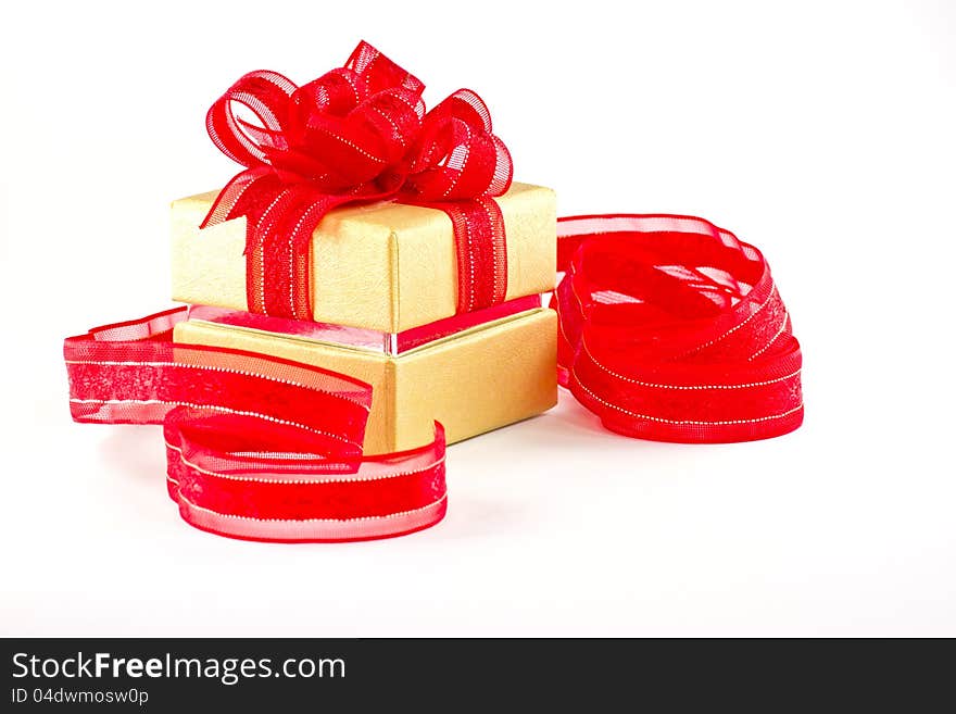 Gift box and red ribbon on white background