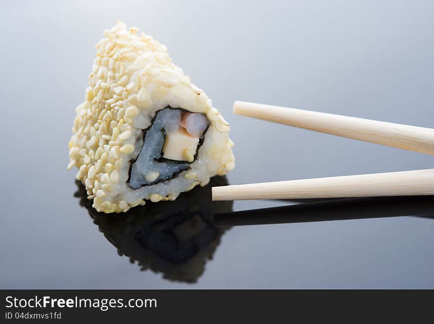 Sushi with sesame and chopsticks