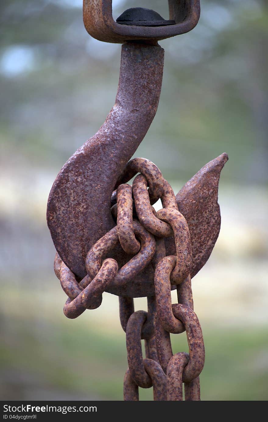 Close up of rusty hook with chain