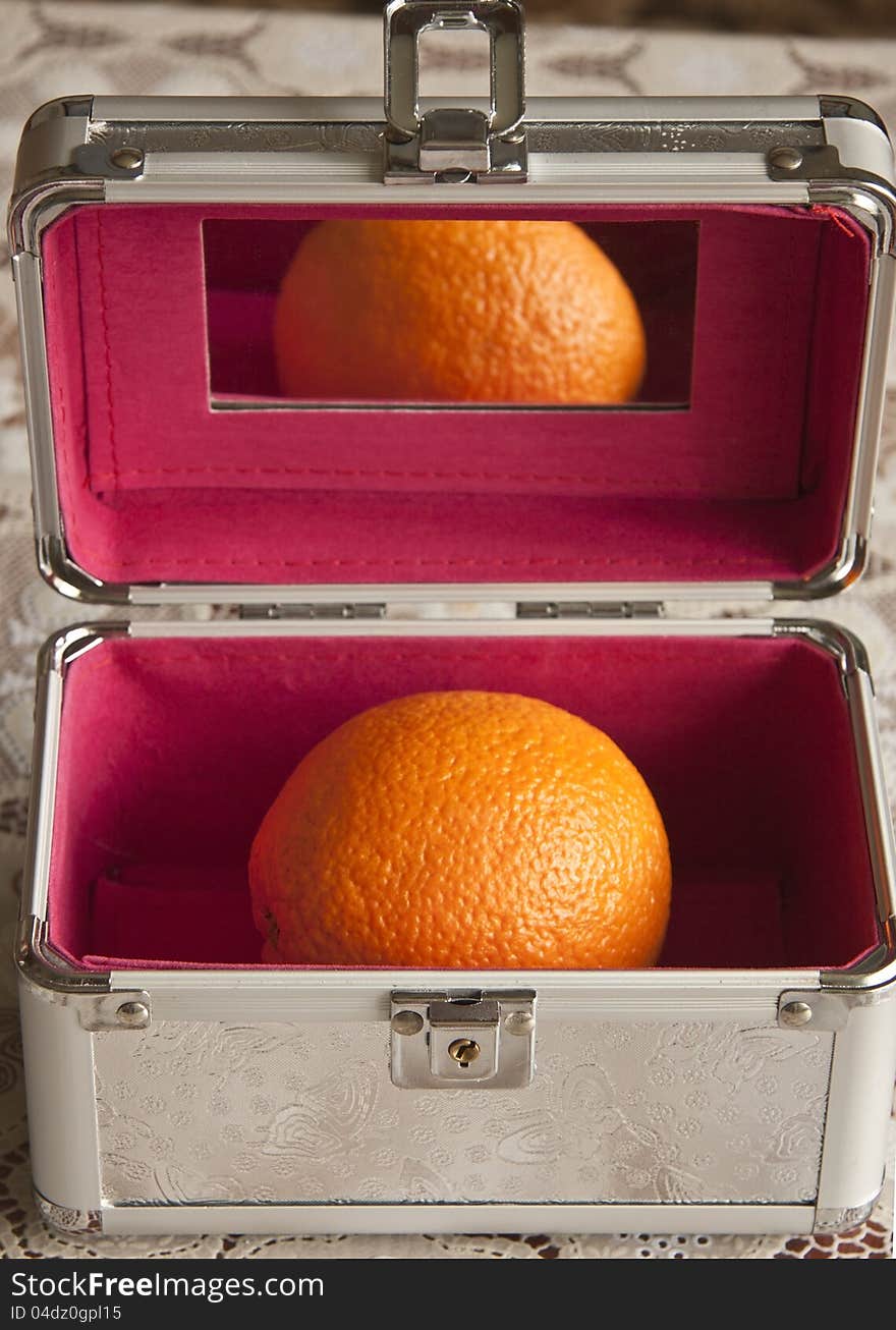 Large orange in a metal trunk. Large orange in a metal trunk