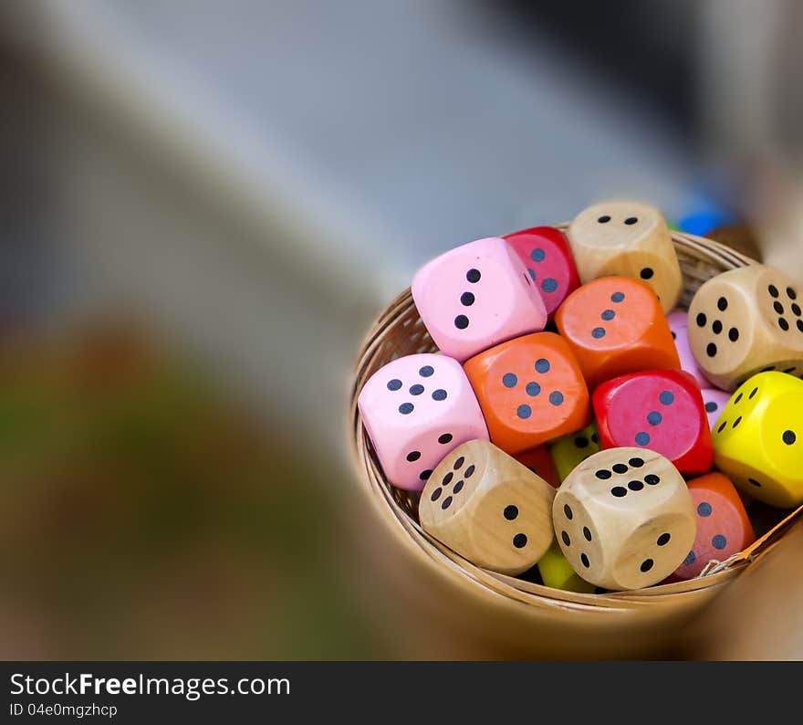 Colored dice in small basket