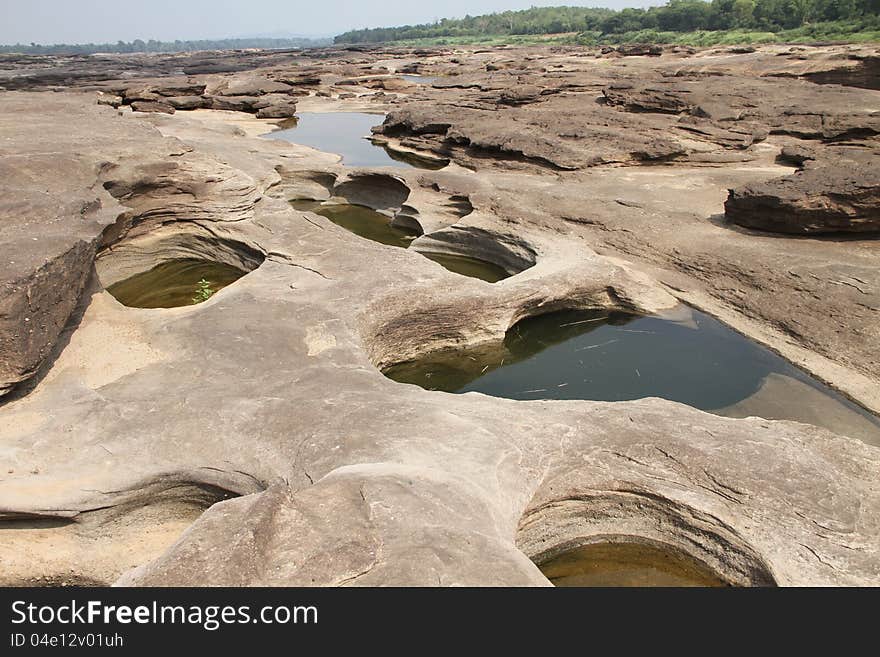 The traces of the river eroded the rock into a beautiful trail along the banks of the Mekong River between Thailand and Laos. The traces of the river eroded the rock into a beautiful trail along the banks of the Mekong River between Thailand and Laos.