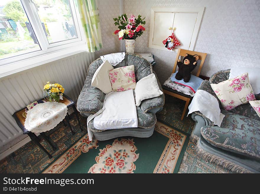 Empty armchair in an old persons home after their passing.