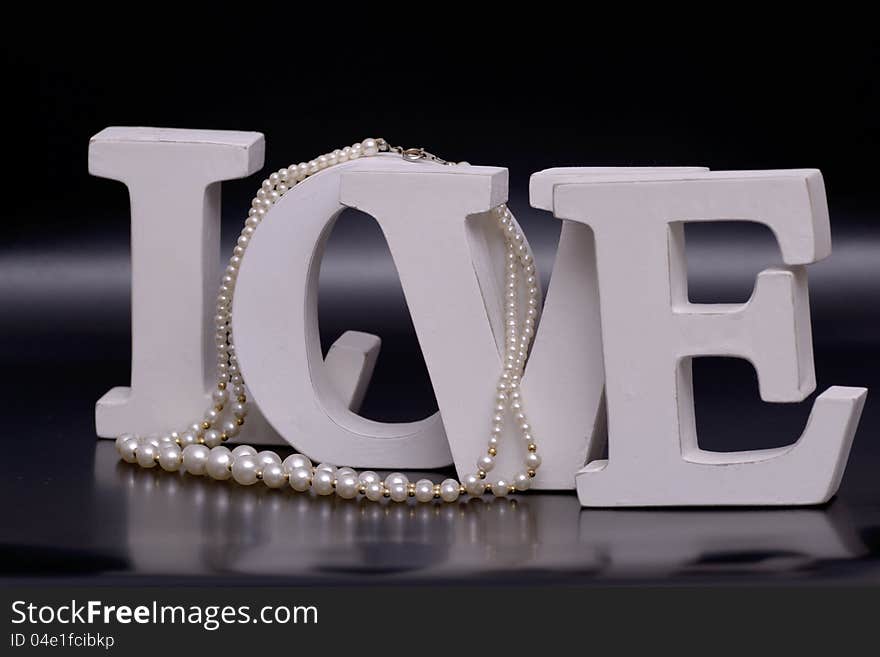 love letters and pearl necklace