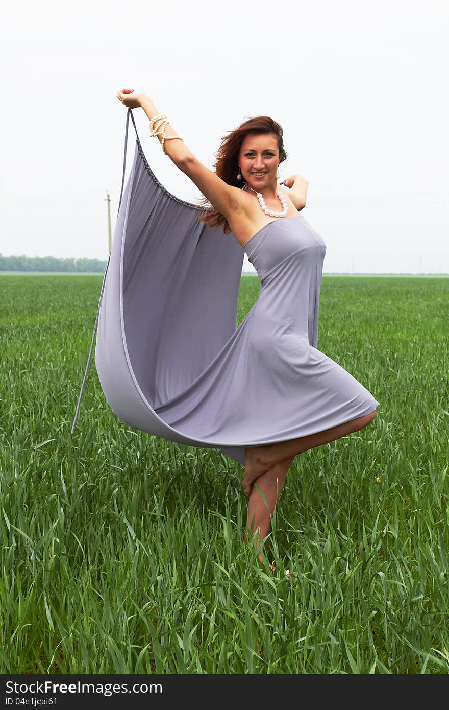 Happy young woman outdoors in the field. Happy young woman outdoors in the field