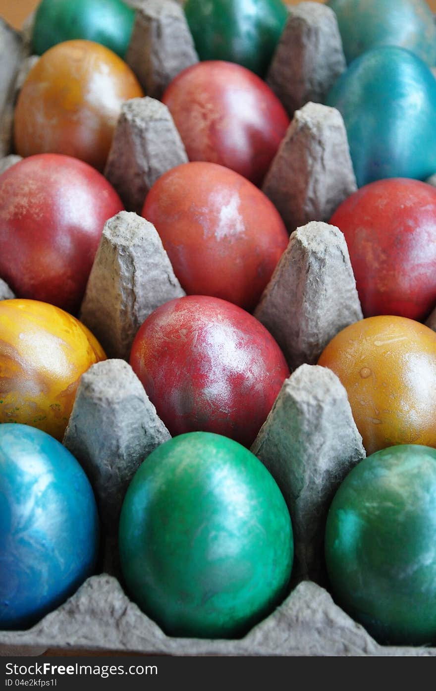 Stack of easter eggs in a carton.