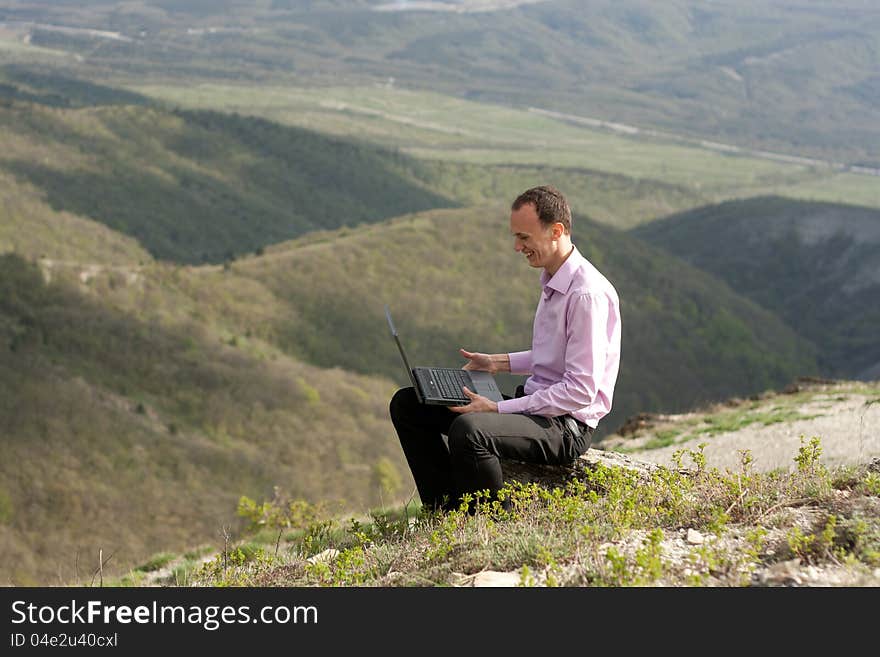 Man with notebook on stone