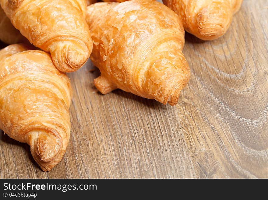 Assortment of baked bread on wood table background