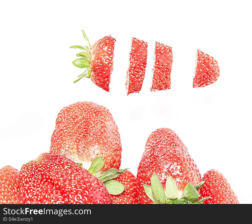 Cut strawberries isolated on white background