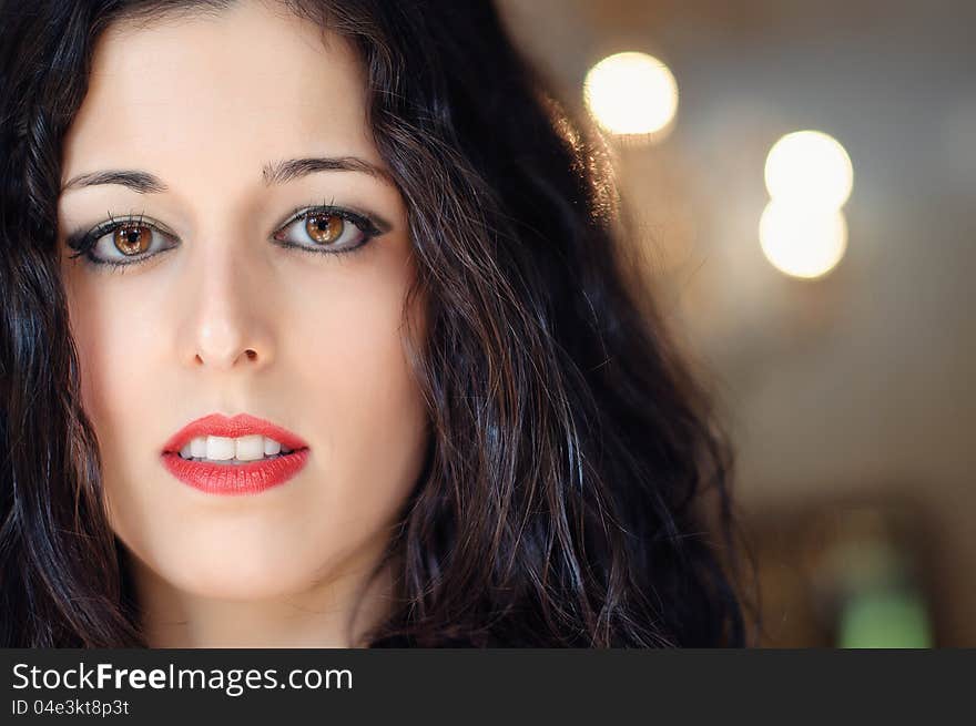 A close up of a brunette woman face, with fair, thin, smooth skin. She has brown eyes and red lips. A close up of a brunette woman face, with fair, thin, smooth skin. She has brown eyes and red lips