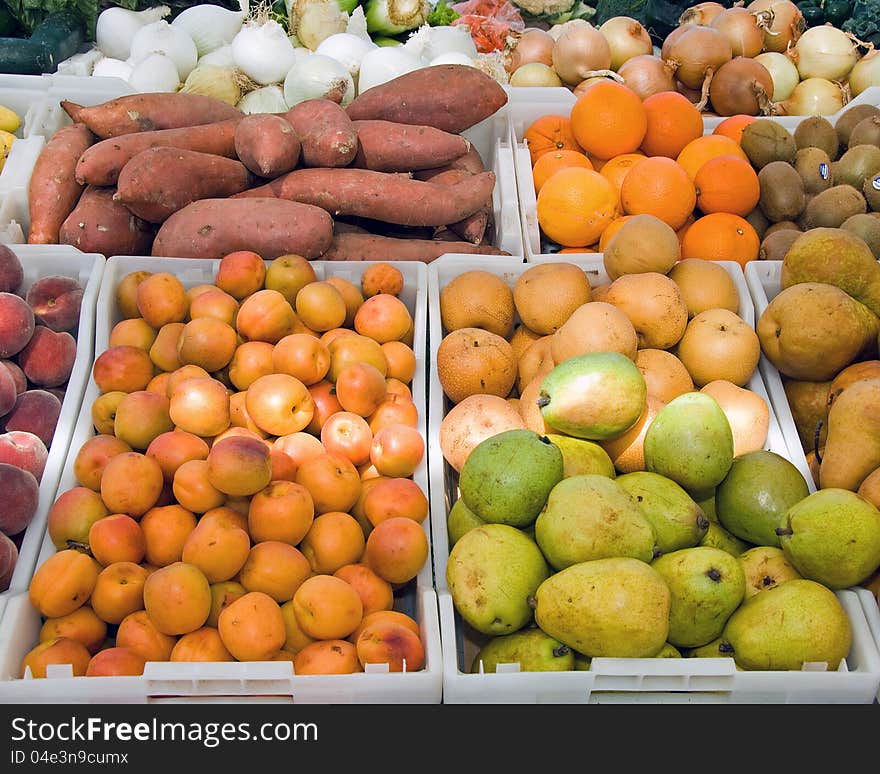 Various bins of fruits and vegetables arranged for purchase. Various bins of fruits and vegetables arranged for purchase.