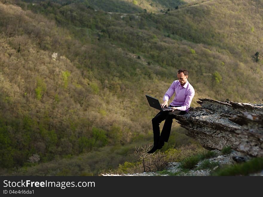 Man with notebook on stone