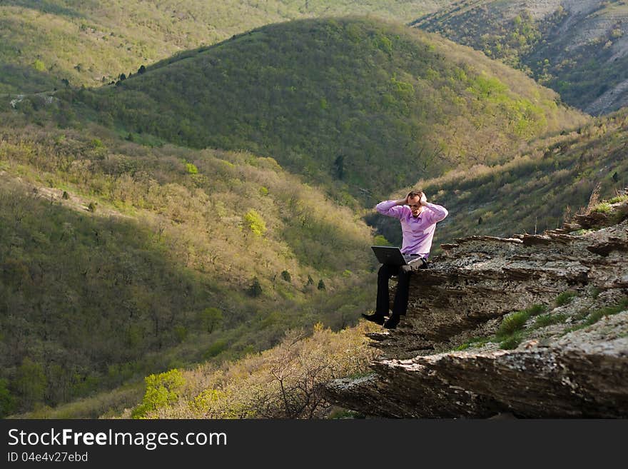 Man with notebook on stone